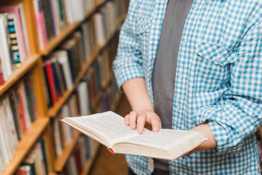 Crop-male-teenager-reading-book.jpg