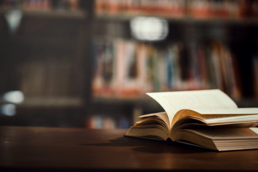 Book-in-library-with-open-textbook.jpg