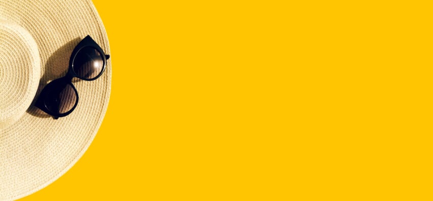 Straw-hat-with-sunglasses-on-yellow.jpg