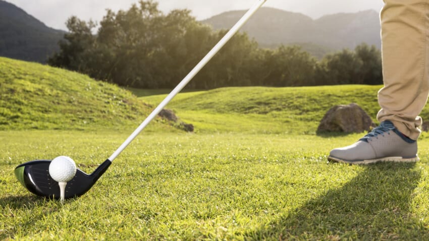 Man-practicing-golf-field.jpg