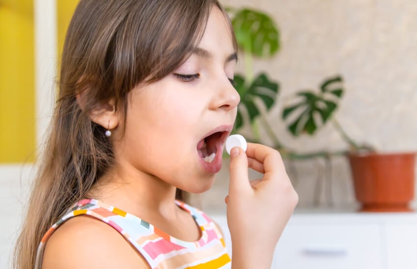 Vitamin-c-pill-to-her-child-dietary-supplements-for-kids-selective-focus-people.jpg