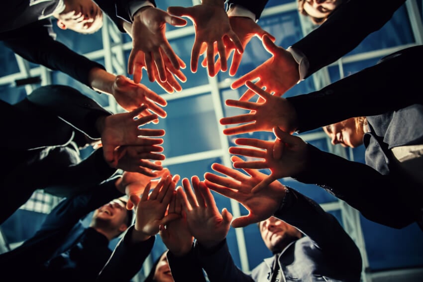 Close-up-young-business-team-standing-in-a-circle.jpg
