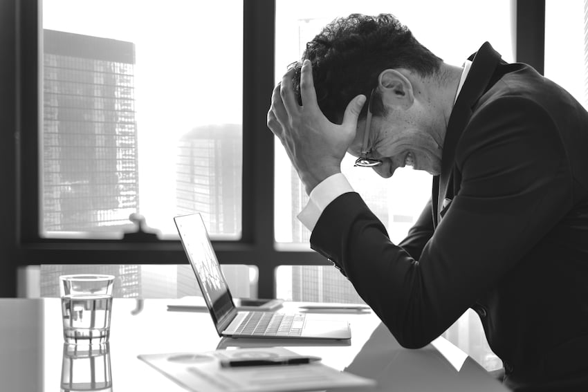 Stressed-young-businessman-overworking.jpg