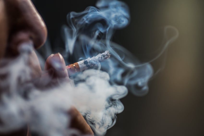 Closeup-shot-of-a-person-puffing-on-a-cigarette-surrounded-with-smoke.jpg