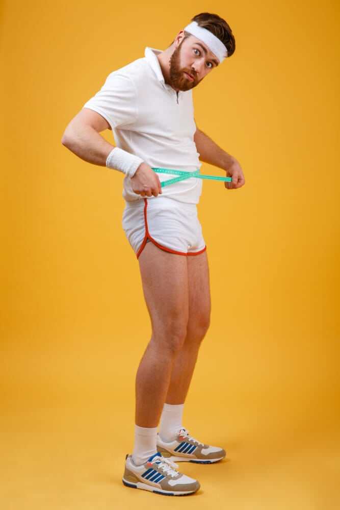 Full-length-portrait-frustrated-man-measuring-his-waist.jpg