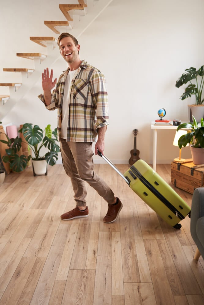 Vertical-portrait-happy-friendly-man-guy-waves-hand-camera-says-hello-bye-goes.jpg